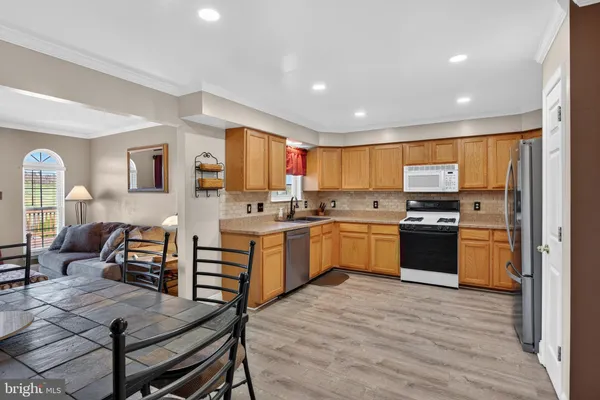 a kitchen with a refrigerator and wooden cabinets