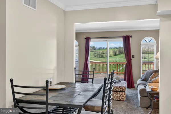 a dining room with furniture and a window
