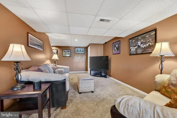 a living room with furniture and a lamp