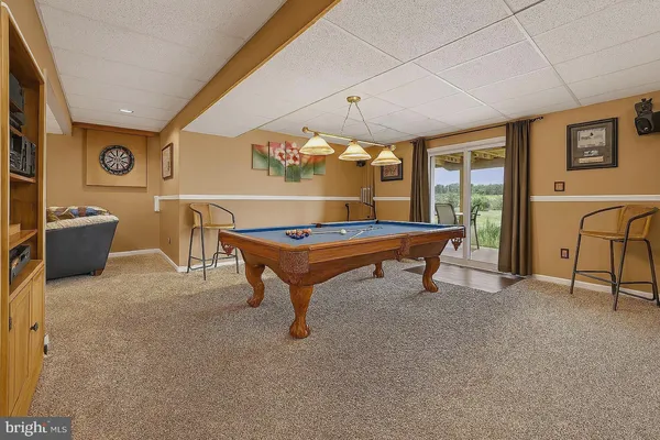 a room with pool table table and windows