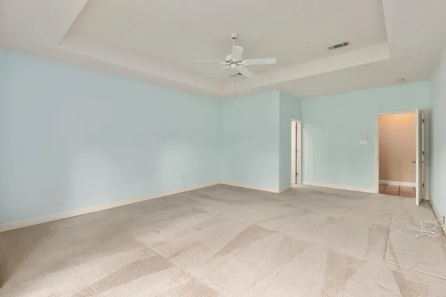 a bathroom with a granite countertop tub double vanity sink and a large mirror
