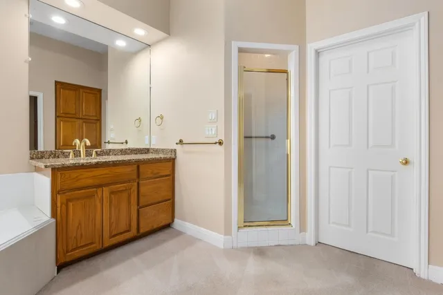 a bathroom with a tub sink and mirror