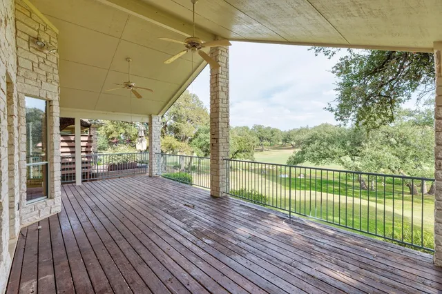 a view of a house with wooden floor next to a yard