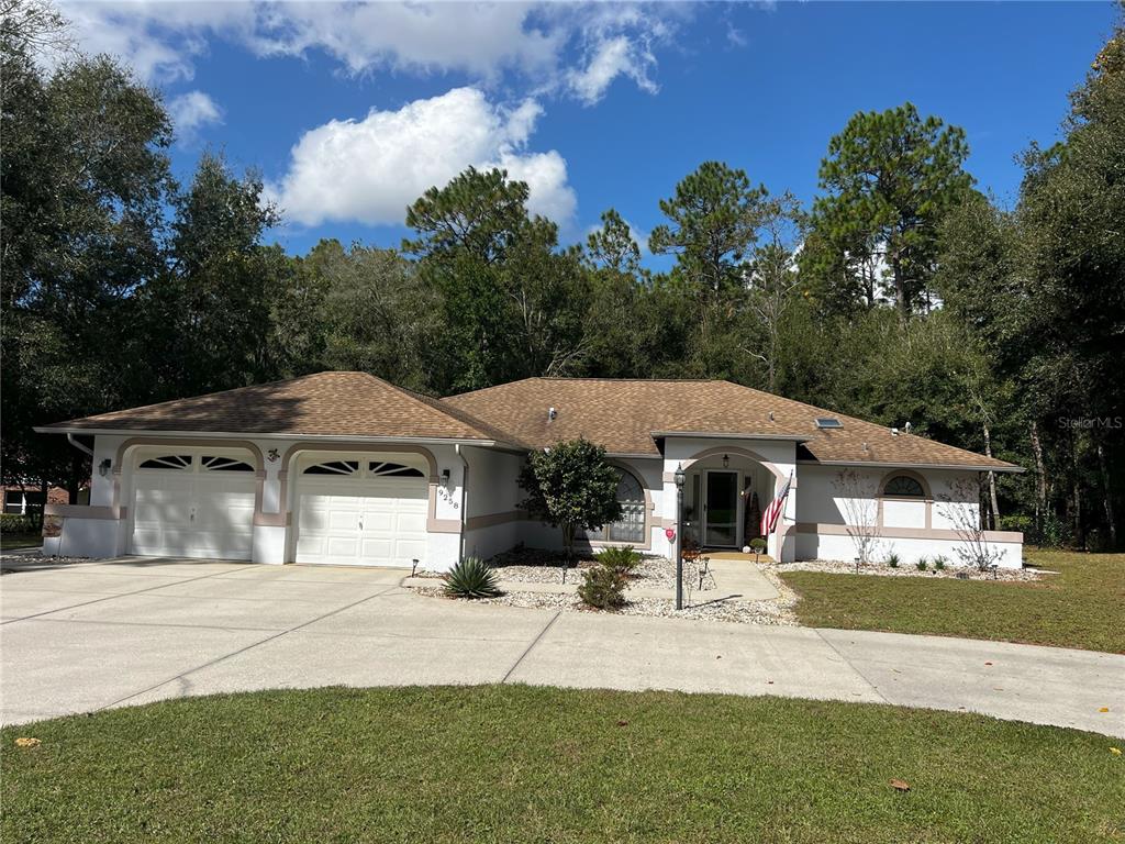 9258 Southwest 202nd Avenue Road Dunnellon, FL 34431 - Photo 1 of 1 a front view of a house with garden