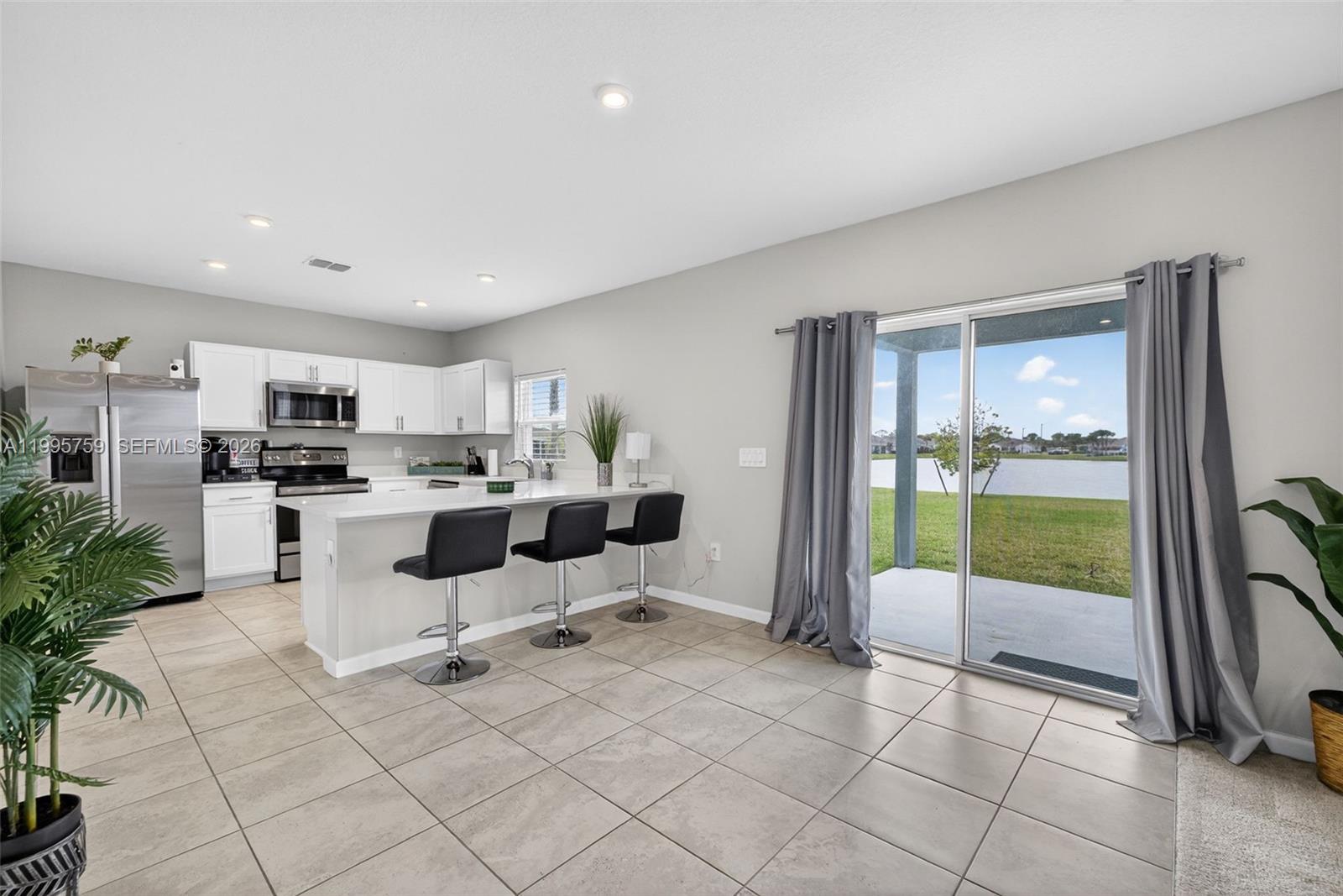 220 Raspberry Road Fort Pierce, FL 34981 - Photo 13 of 43 a living room with furniture a floor to ceiling window and entryway