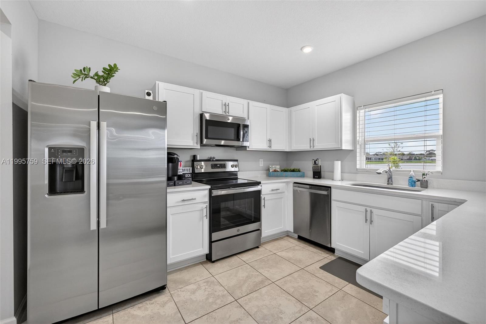 220 Raspberry Road Fort Pierce, FL 34981 - Photo 15 of 43 a kitchen with cabinets stainless steel appliances and window