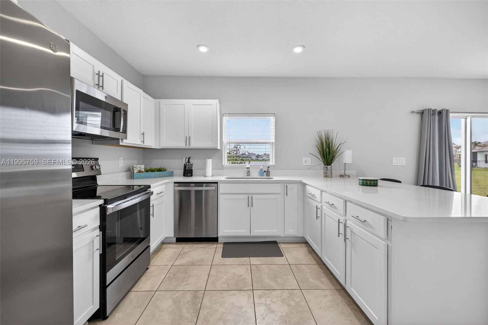 220 Raspberry Road Fort Pierce, FL 34981 - Photo 16 of 43 a kitchen with a sink and cabinets