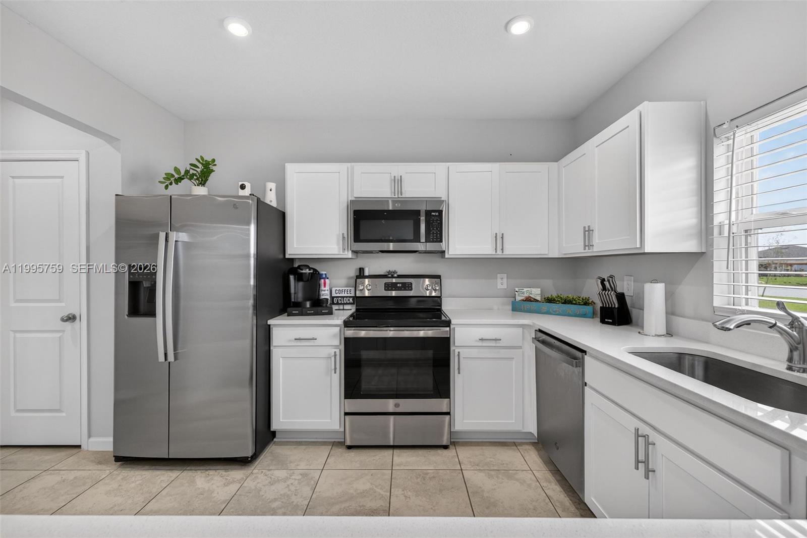 220 Raspberry Road Fort Pierce, FL 34981 - Photo 17 of 43 a kitchen with a white stove top oven and refrigerator