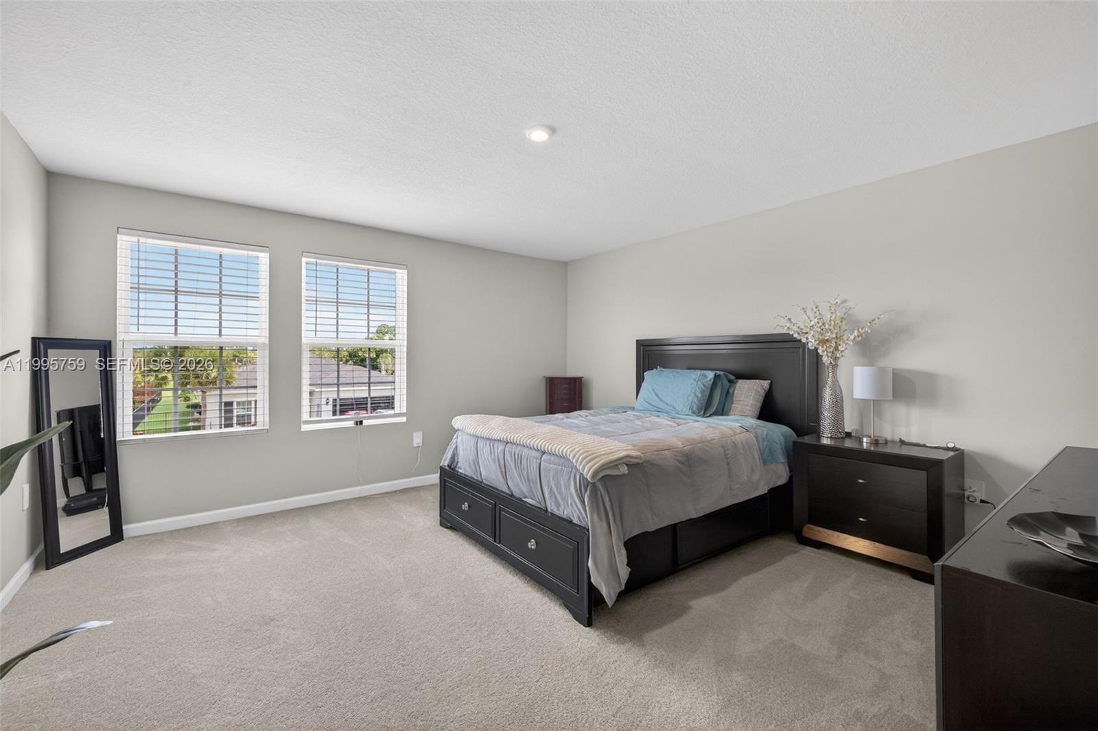 220 Raspberry Road Fort Pierce, FL 34981 - Photo 22 of 43 a spacious bedroom with a bed and a large window
