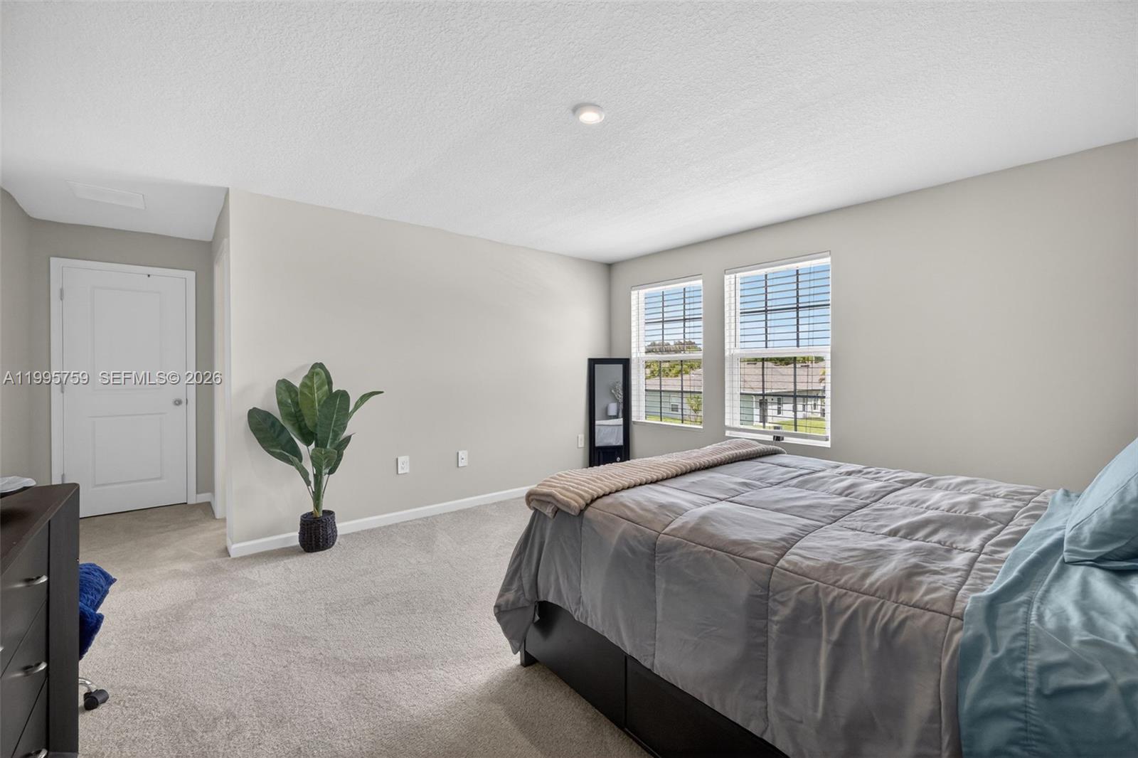 220 Raspberry Road Fort Pierce, FL 34981 - Photo 23 of 43 a bedroom with a bed and a potted plant