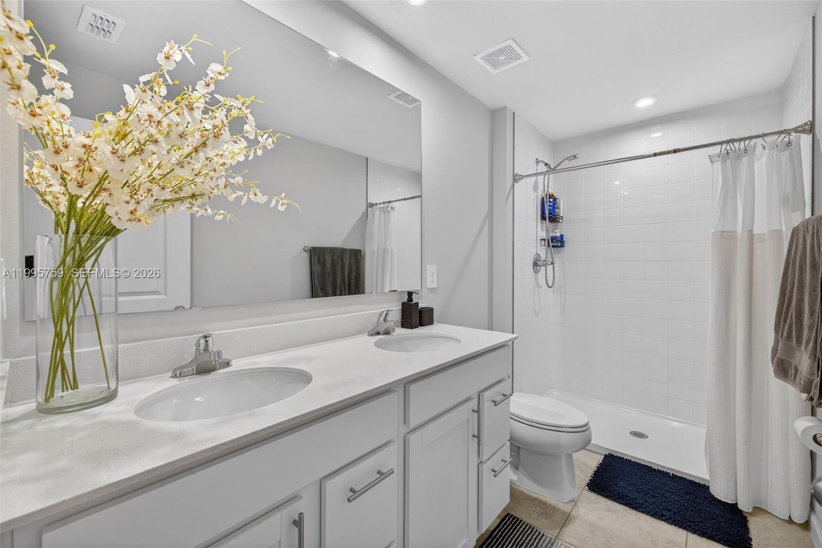 220 Raspberry Road Fort Pierce, FL 34981 - Photo 26 of 43 a bathroom with a granite countertop sink a toilet and a mirror