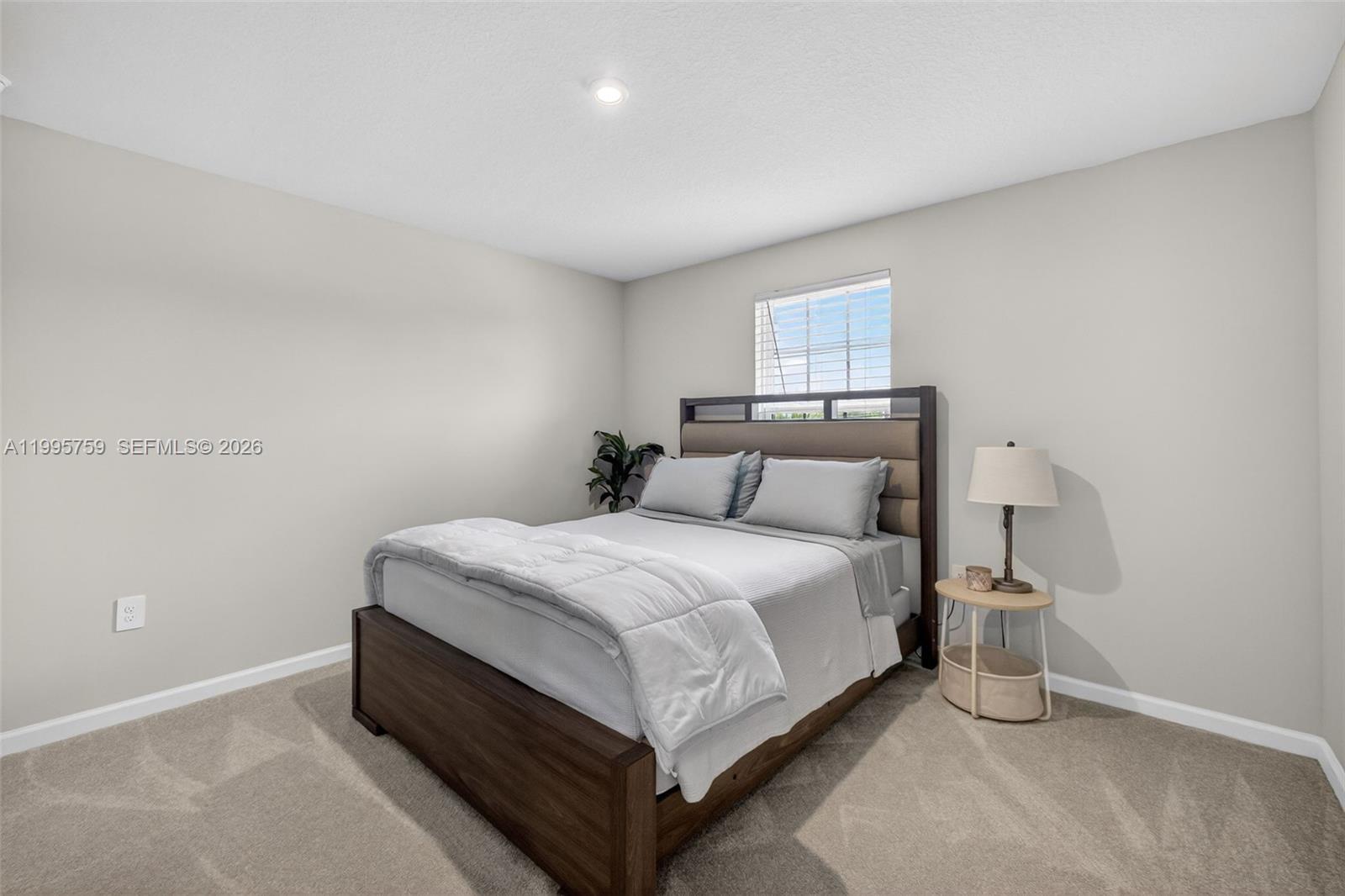 220 Raspberry Road Fort Pierce, FL 34981 - Photo 27 of 43 a bed room with a bed and a night stand