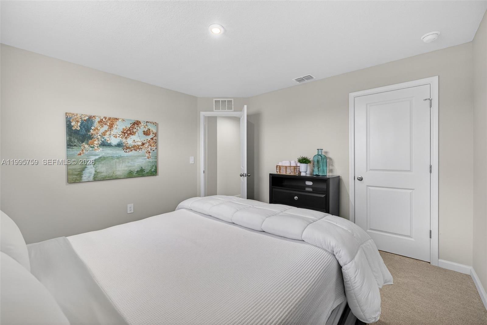 220 Raspberry Road Fort Pierce, FL 34981 - Photo 28 of 43 a bedroom with a bed and a painting on the wall