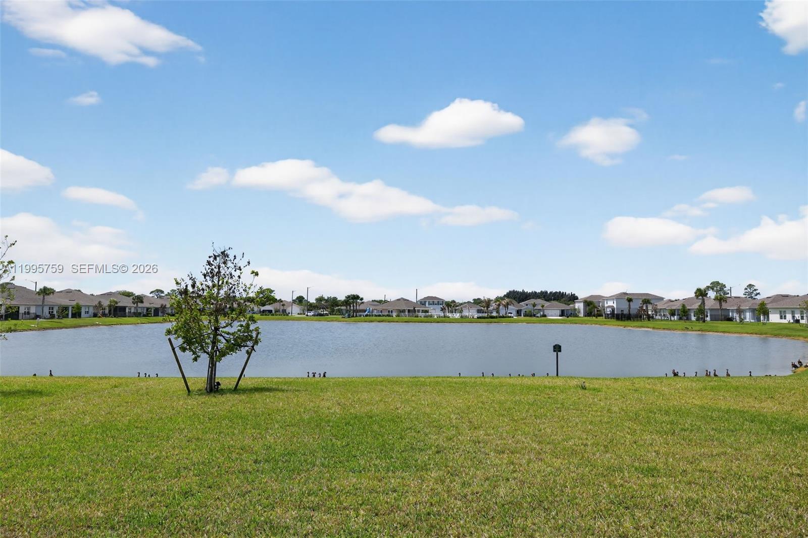 220 Raspberry Road Fort Pierce, FL 34981 - Photo 36 of 43 a view of a lake and yard in the back