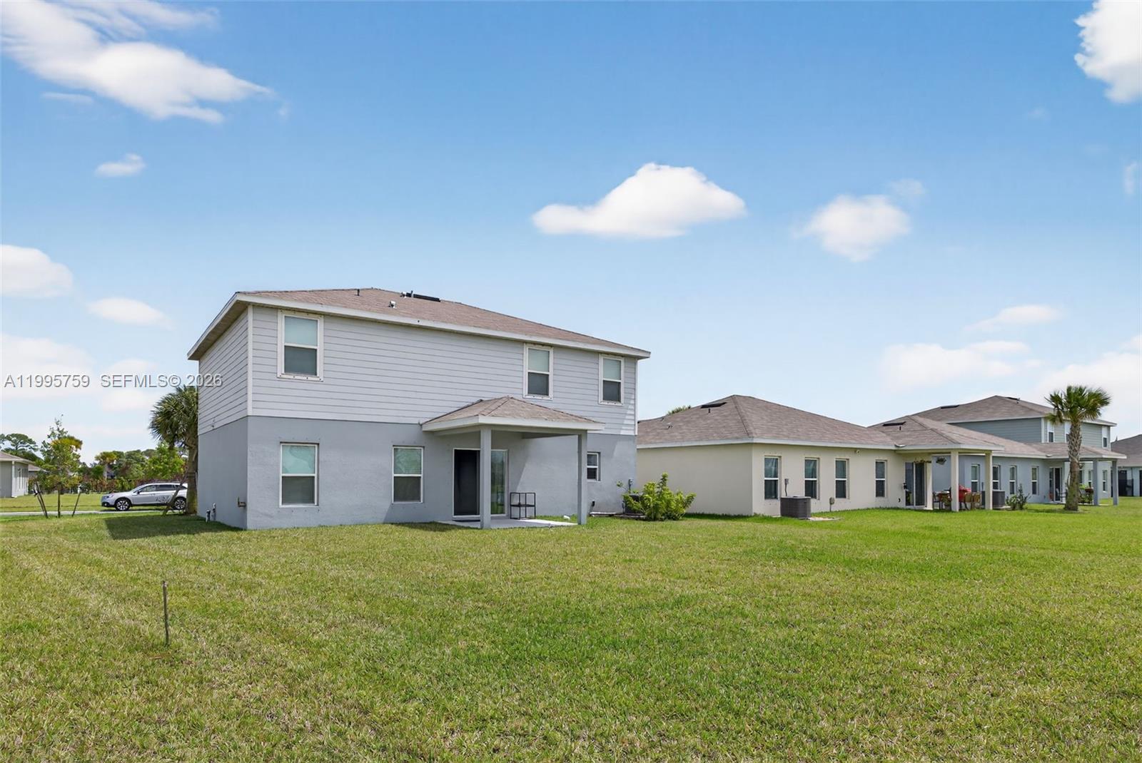 220 Raspberry Road Fort Pierce, FL 34981 - Photo 40 of 43 a front view of a house with a garden