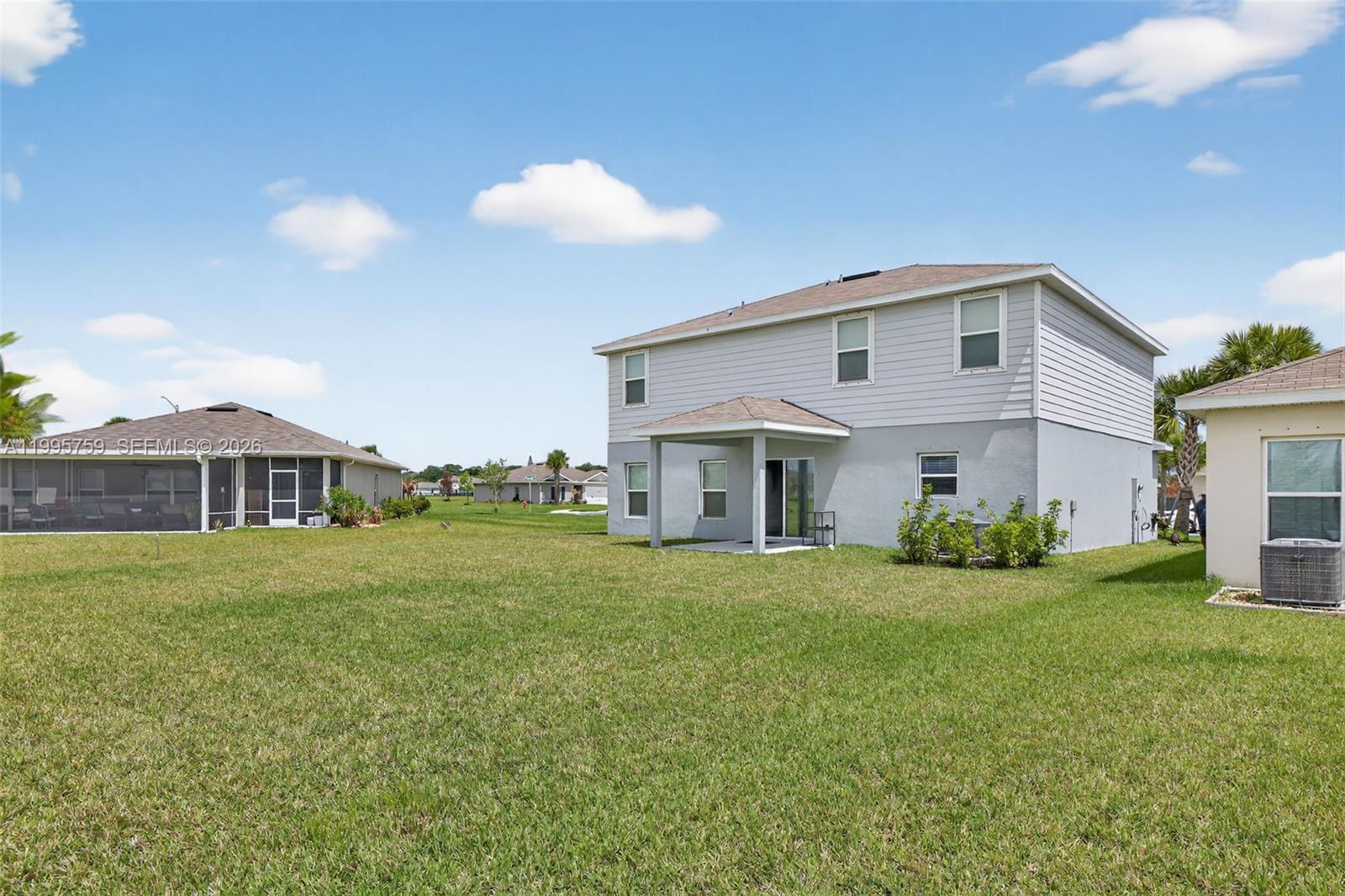 220 Raspberry Road Fort Pierce, FL 34981 - Photo 41 of 43 a front view of a house with a yard