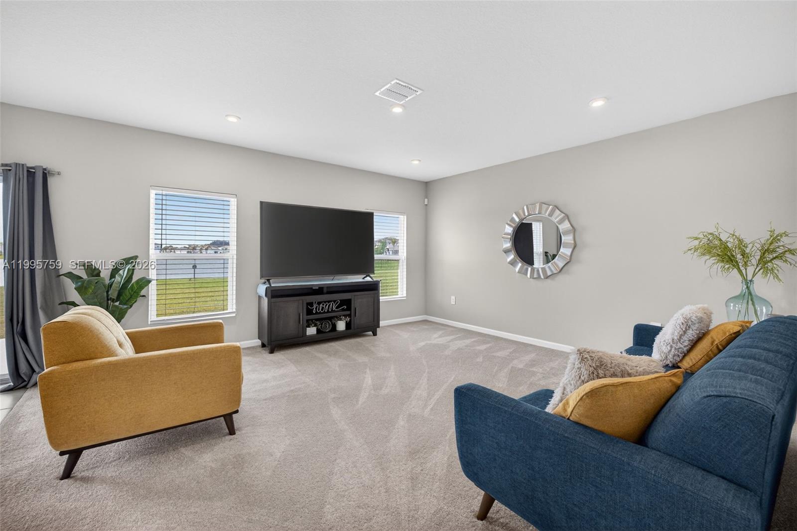 220 Raspberry Road Fort Pierce, FL 34981 - Photo 9 of 43 a living room with furniture and a flat screen tv