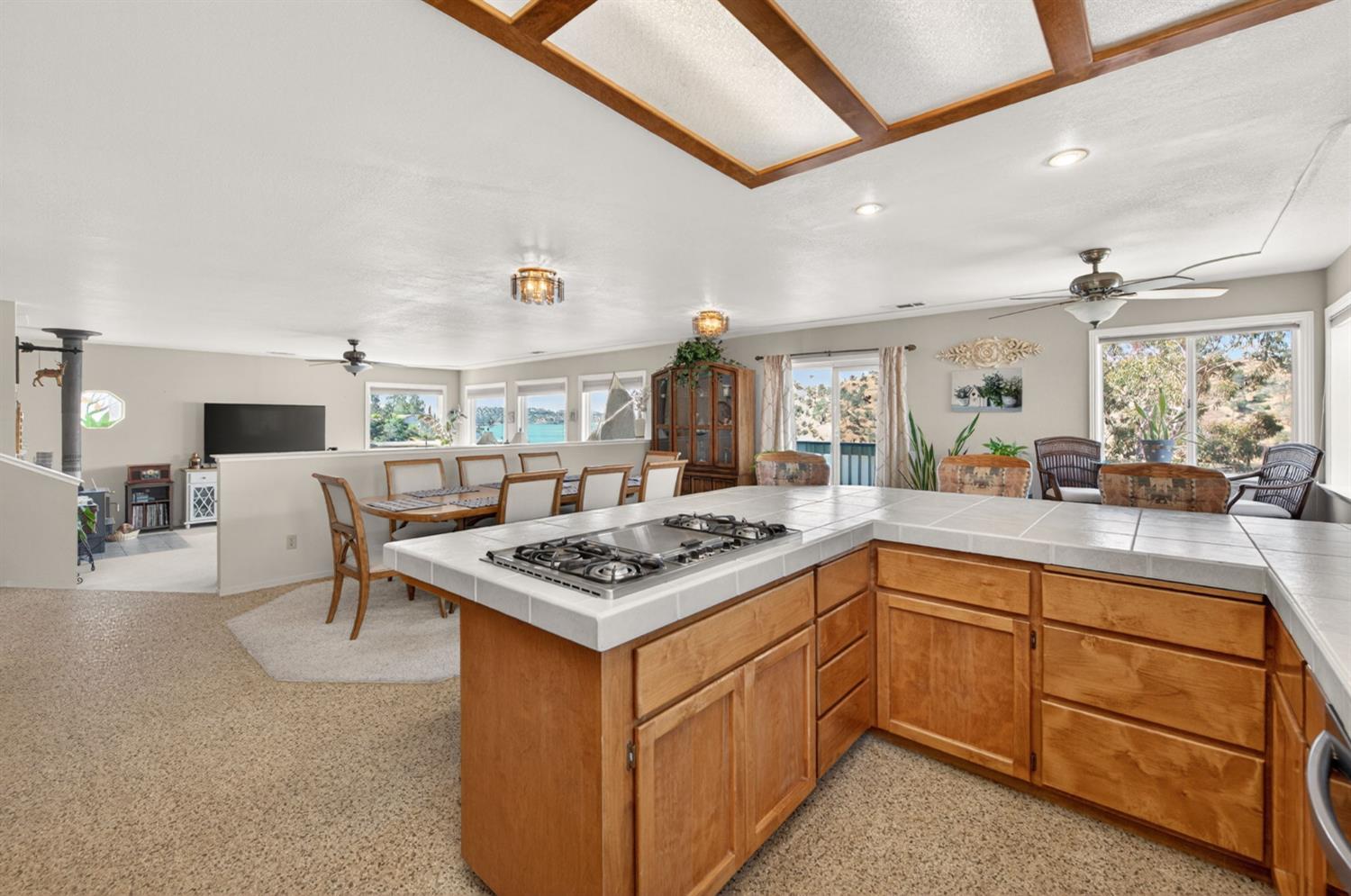 28037 Sky Harbour Road Friant, CA 93626 - Photo 11 of 40 a kitchen with a stove a table and chairs in it