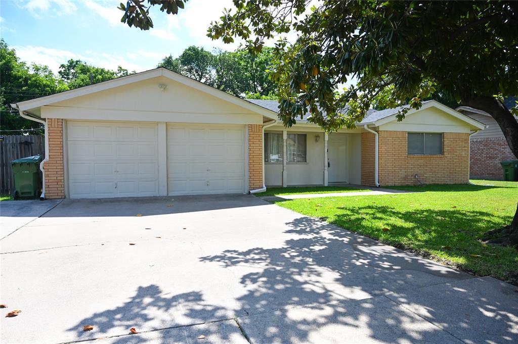 1352 Simpson Drive Hurst, TX 76053 - Photo 3 of 40 Single-story residence featuring a two-car garage, concrete driveway, brick and siding exterior, front lawn, and mature tree
