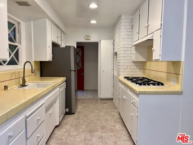 an empty room with wooden floor and a window
