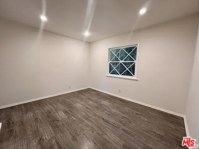 a bathroom with a granite countertop sink a toilet and a mirror