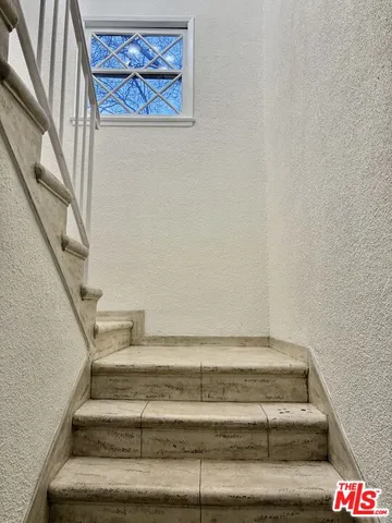 a kitchen with granite countertop white cabinets and stainless steel appliances