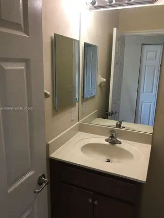 a bathroom with a sink and mirror