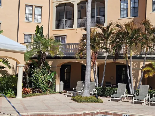 a living room with furniture fireplace and a large window