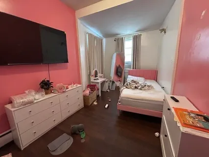 a bedroom with a bed and flat screen tv