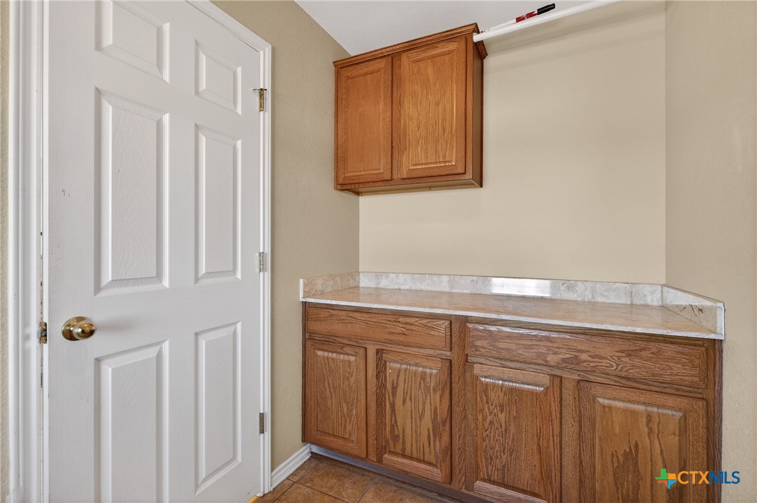 8407 Shaw Road Rogers, TX 76569 - Photo 13 of 25 a view of a kitchen with white cabinets