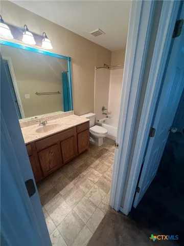 a view of a utility room with cabinets