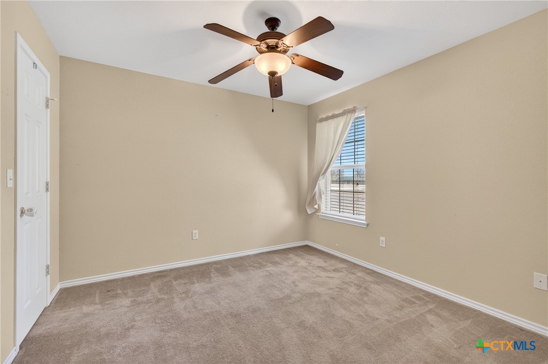 8407 Shaw Road Rogers, TX 76569 - Photo 21 of 25 an empty room with windows and fan