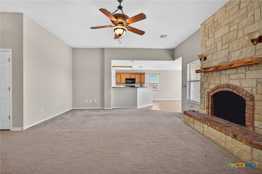 8407 Shaw Road Rogers, TX 76569 - Photo 8 of 25 a view of an empty room with a fireplace and a window