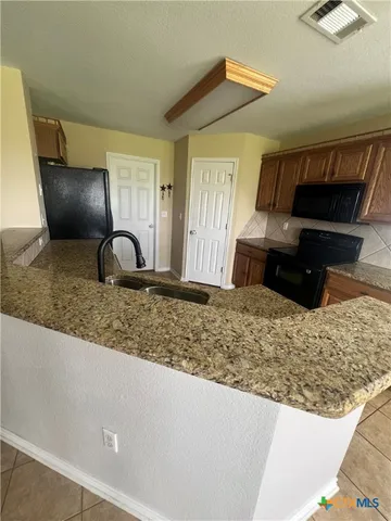 a view of wooden floor and window in a room