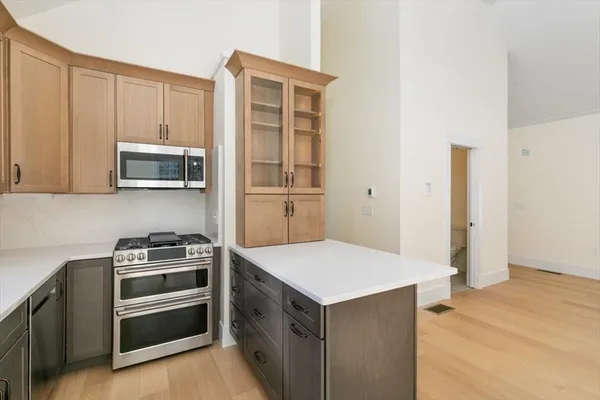 a kitchen with stainless steel appliances a stove a microwave and a refrigerator