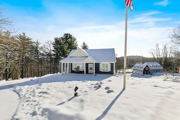 a view of a roof covered with snow in the background