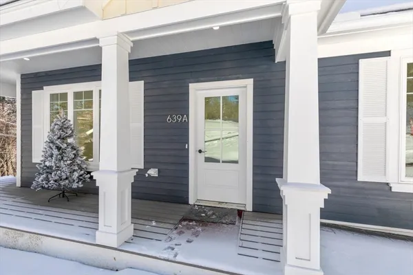 a front view of a house with potted plants