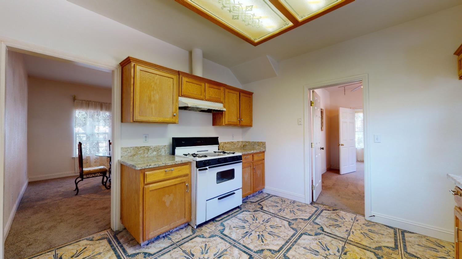 926 North Frankwood Avenue Reedley, CA 93654 - Photo 12 of 32 a kitchen with stainless steel appliances granite countertop a stove a sink and a microwave