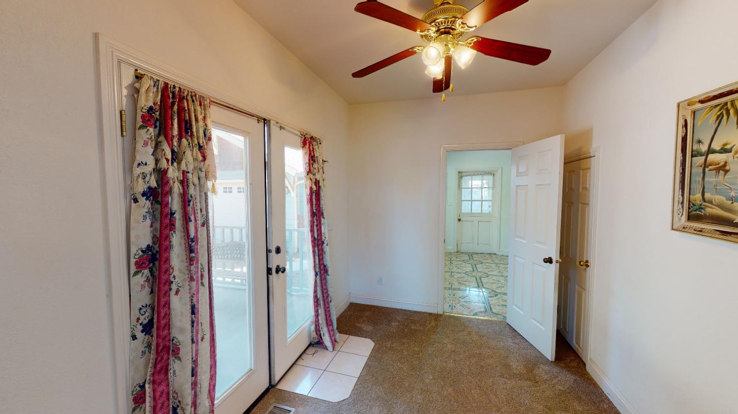 926 North Frankwood Avenue Reedley, CA 93654 - Photo 14 of 32 a view of a hallway with closet and a chandelier fan