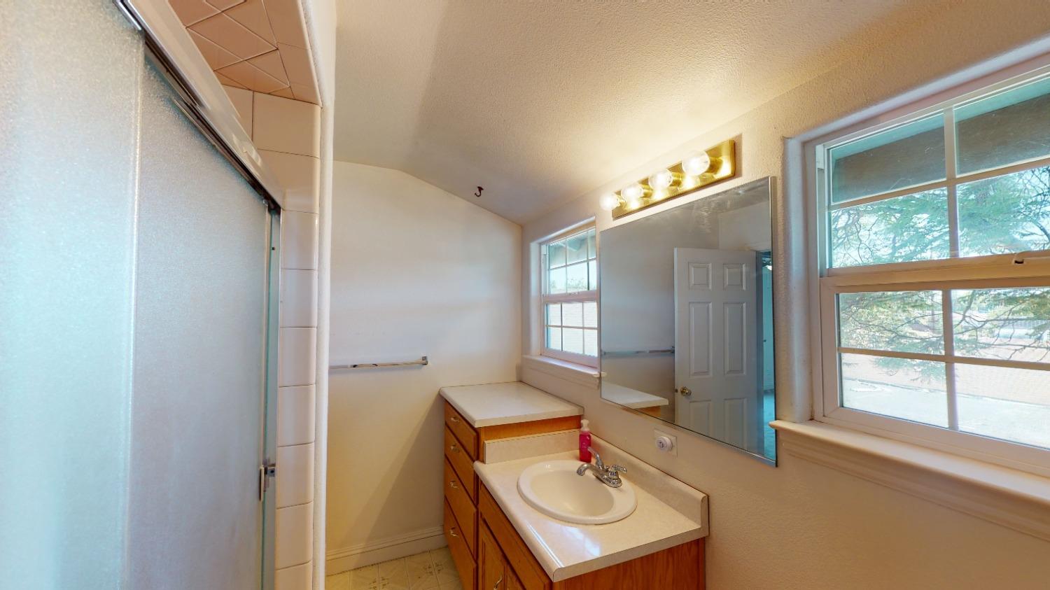 926 North Frankwood Avenue Reedley, CA 93654 - Photo 19 of 32 a view of a room that has a bed and a table in it
