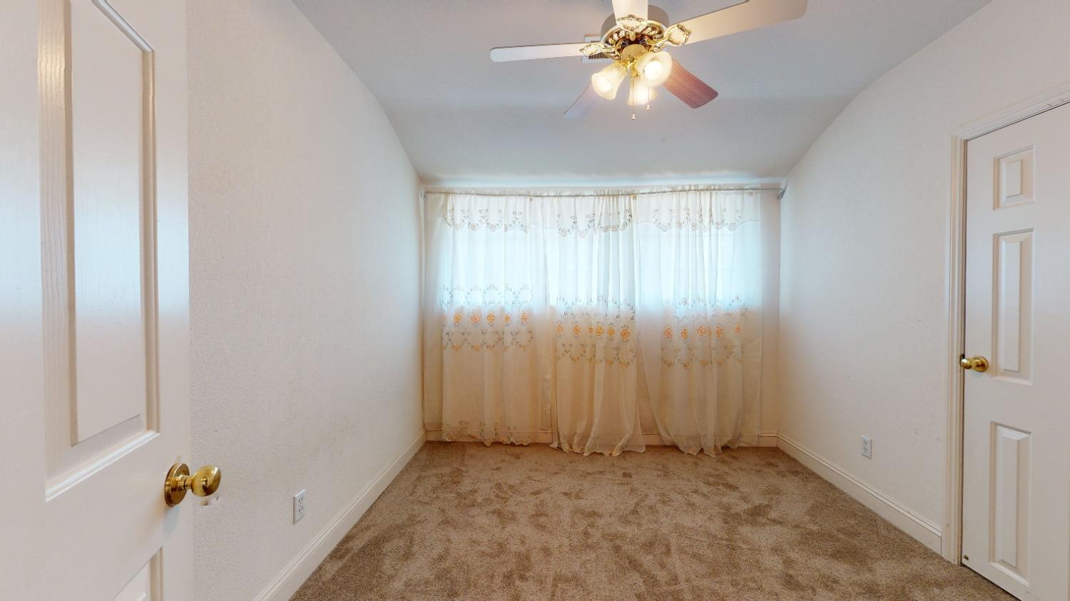 926 North Frankwood Avenue Reedley, CA 93654 - Photo 22 of 32 an empty room with windows and fan