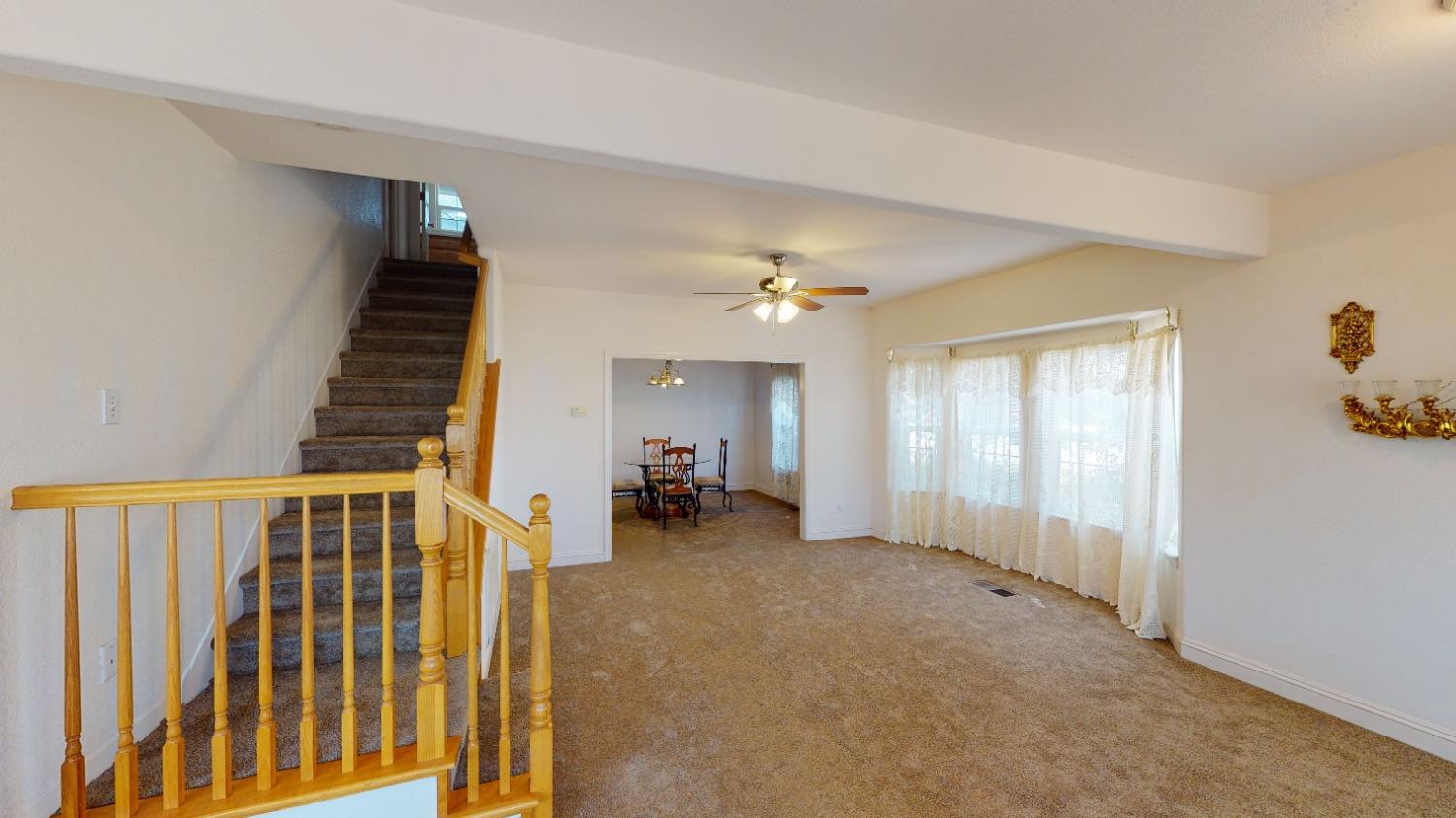 926 North Frankwood Avenue Reedley, CA 93654 - Photo 7 of 32 a view of a hallway with entryway and stairs