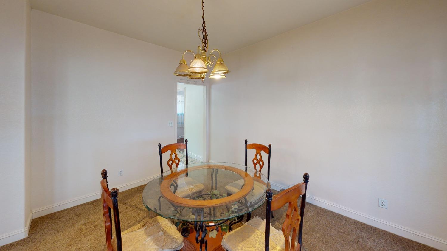 926 North Frankwood Avenue Reedley, CA 93654 - Photo 10 of 32 a view of a dining room with furniture and chandelier