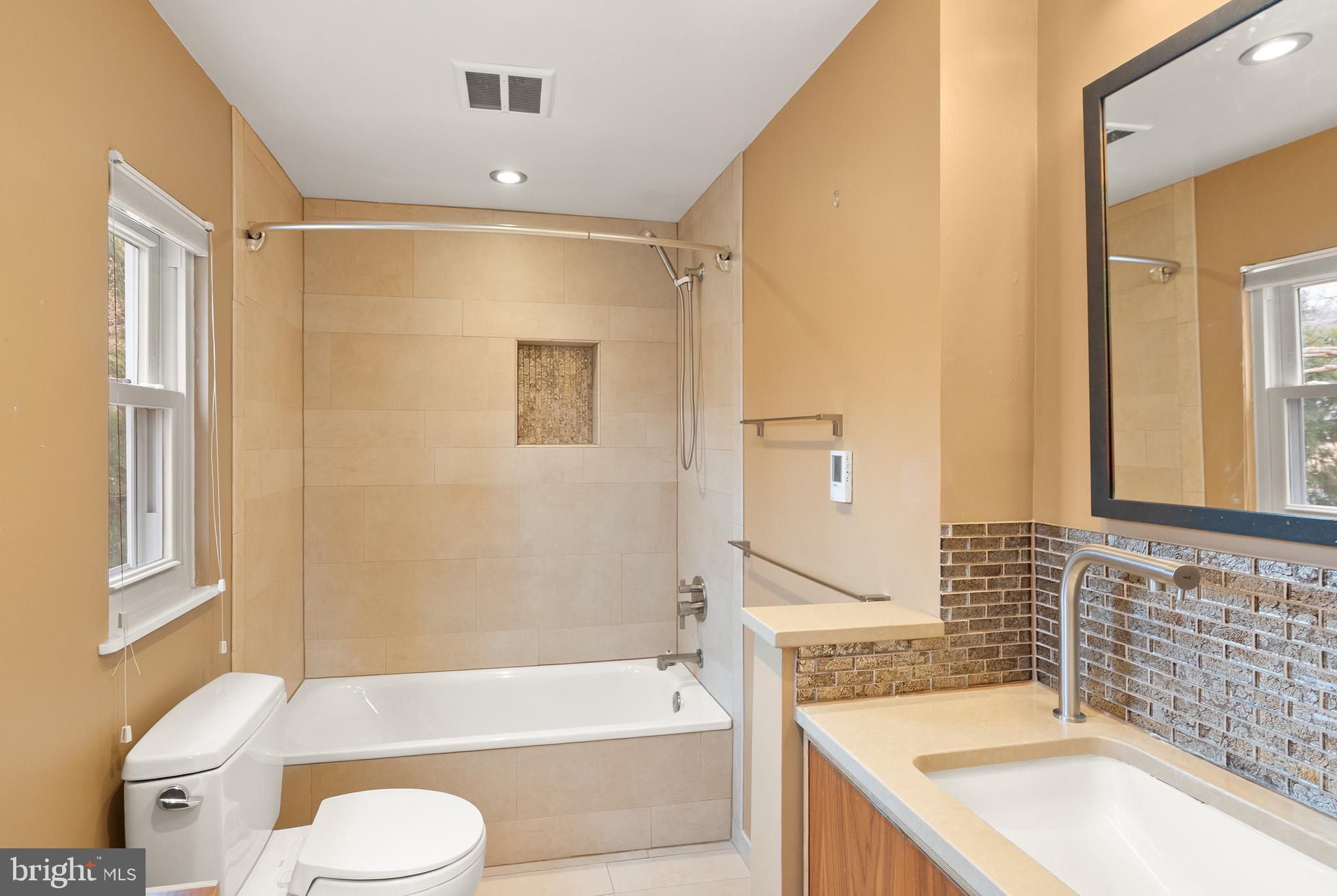5004 Regency Place Alexandria, VA 22304 - Photo 15 of 36 a bathroom with a granite countertop sink toilet and shower