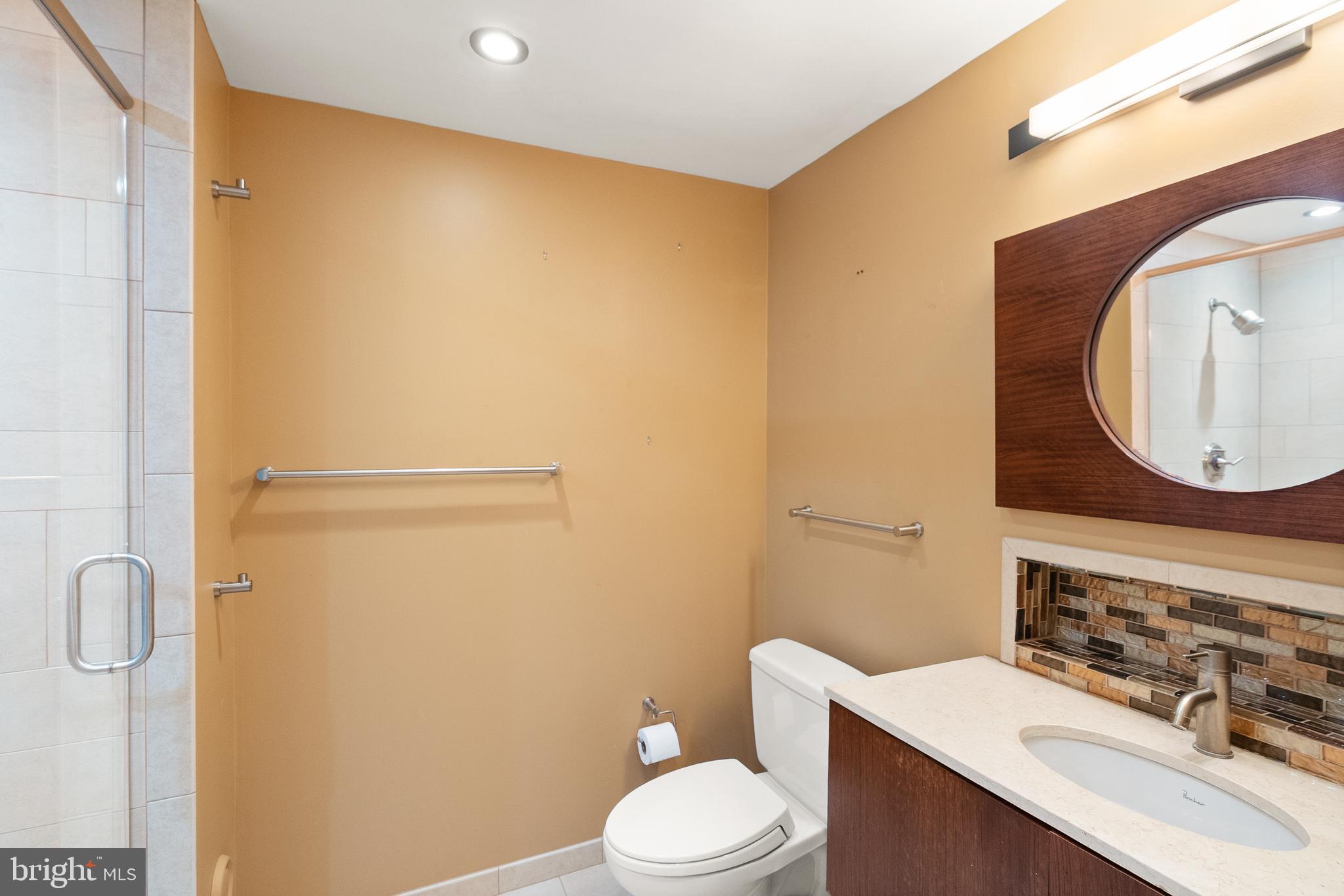 5004 Regency Place Alexandria, VA 22304 - Photo 18 of 36 a bathroom with a sink mirror vanity and toilet