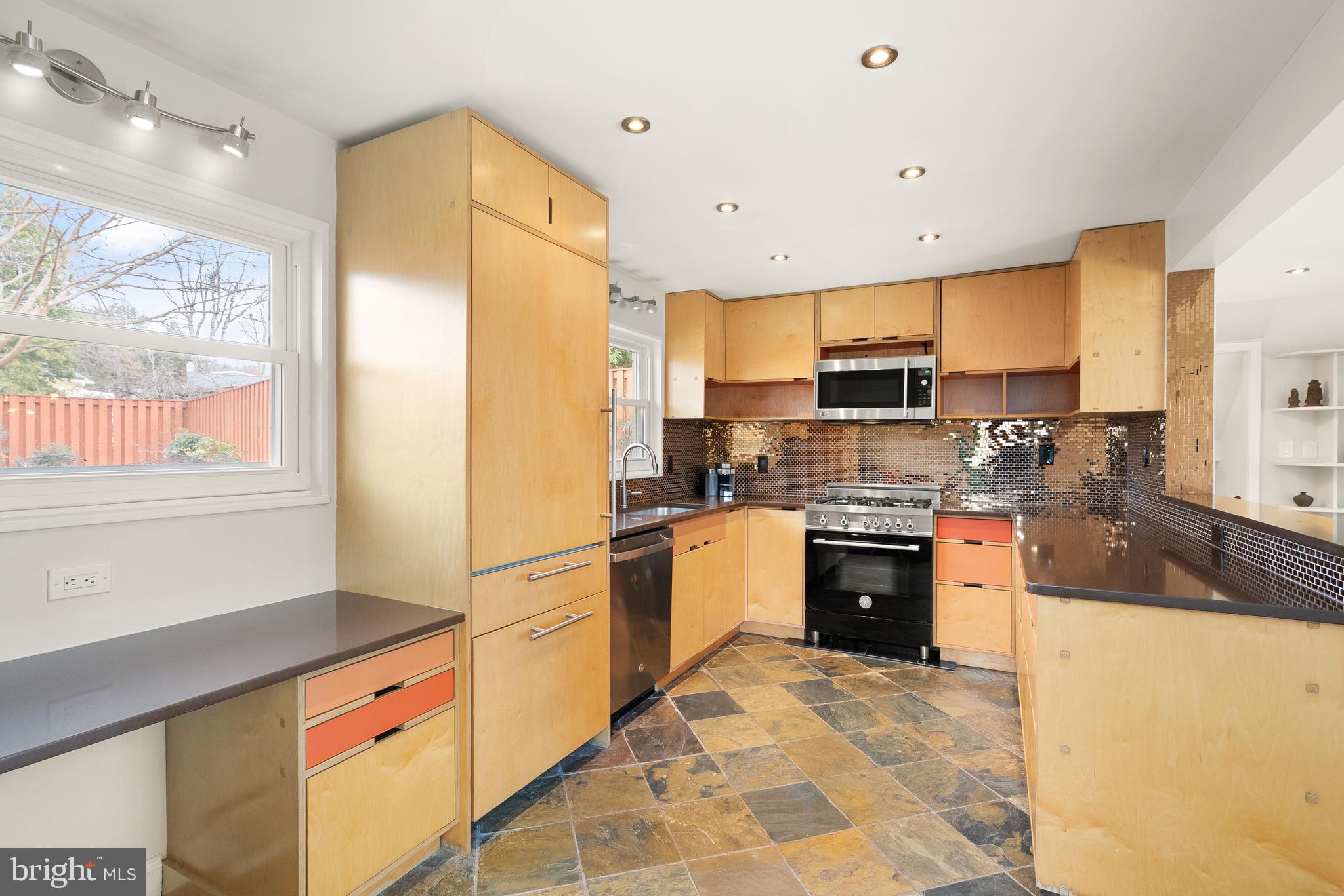 5004 Regency Place Alexandria, VA 22304 - Photo 8 of 36 a kitchen with stainless steel appliances granite countertop a refrigerator a stove top oven and a sink with wooden floor
