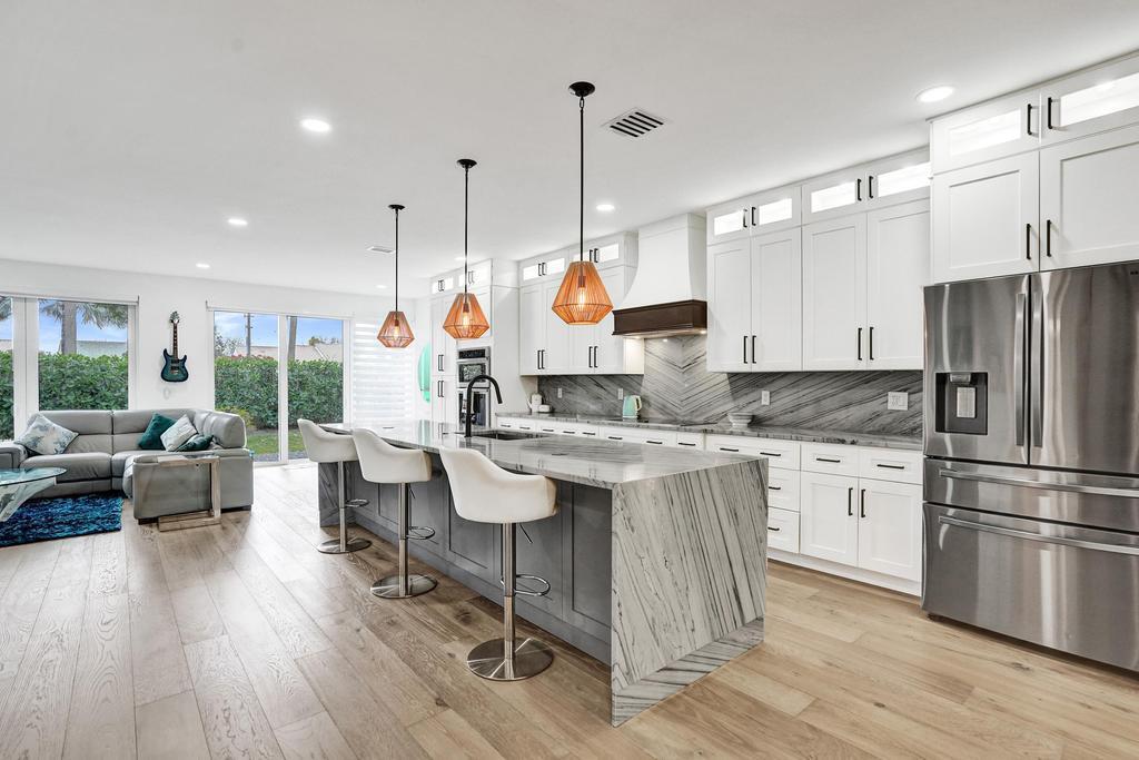 a kitchen with a table chairs stove a refrigerator and furniture