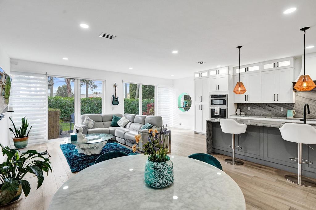6800 Via Regina Boca Raton, FL 33433 - Photo 21 of 58 a living room with fireplace furniture and a large window