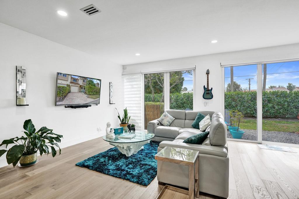 6800 Via Regina Boca Raton, FL 33433 - Photo 22 of 58 a living room with furniture potted plant and a large window