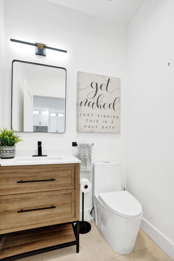 6800 Via Regina Boca Raton, FL 33433 - Photo 23 of 58 a bathroom with a toilet a sink and mirror
